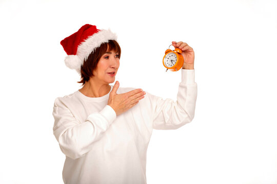 Woman in santa hat holding alarm clock