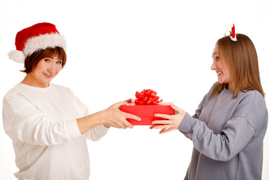 Mother giving christmas gift to happy daughter
