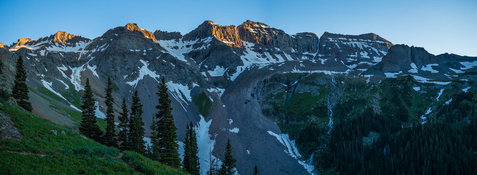 Mountain range with patches of snow at sunset with clear skies