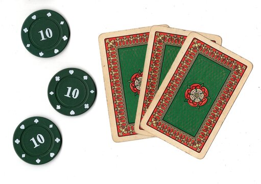 A hand of vintage playing cards and poker chips isolated on a white background.