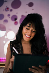 Close up portrait of smiling Caucasian female freelancer writing on digital tablet with stylus pen indoors, managing remote freelancing deliverables vector artwork and creative design © BullRun