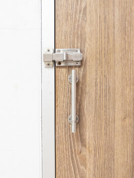 Stainless Steel Slide Latch on Wooden Door