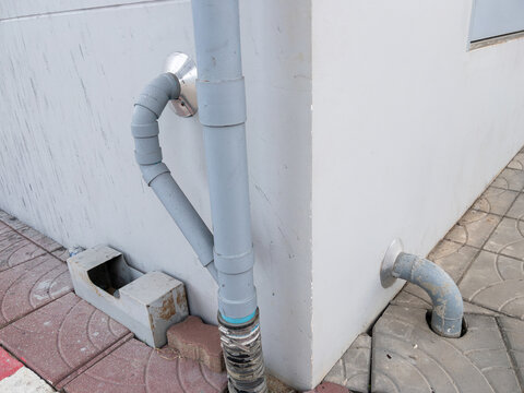 Outdoor Plastic Drainage and Rainwater Downspout Pipe System on Building Wall