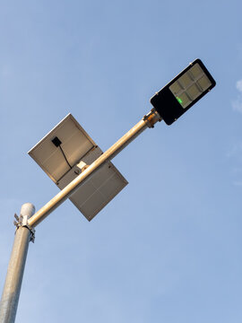 Solar Powered LED Street Light Pole Against Clear Blue Sky Background