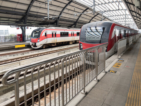 Modern Red Line Commuter Electric Trains Parked at Railway Station Platform