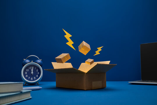 Open cardboard box with bright yellow lightning bolts