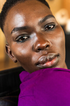 Close-up of a Woman With Dark Skin and Short Hair in a Casual Setting