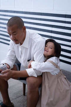 Loving Daughter Hugging Her Father at Home