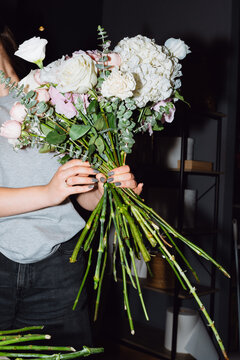 Florist tying a handmade flower bouquet