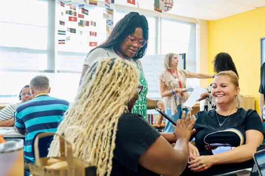 Teachers laughing in a School meeting