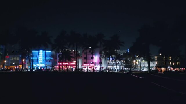 Aerial view of Collins Avenue's glowing neon facade at night