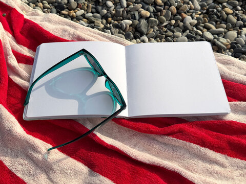Sunglasses on blank notebook