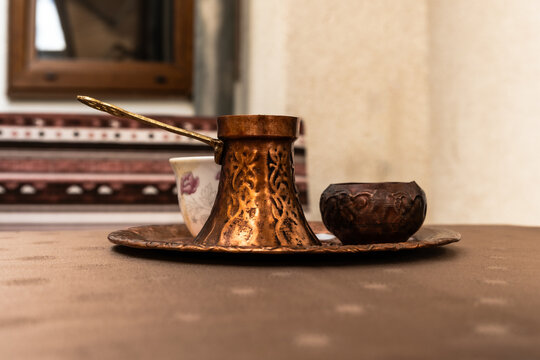 Traditional Bosnian coffee set with copper cezve and cup on a table in Mostar