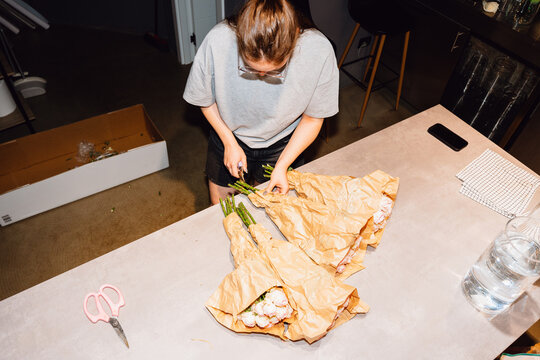 Florist Preparing Fresh Roses for Arrangement