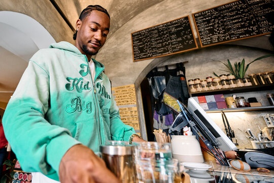 Customer Picking Up Order at Cafe Counter