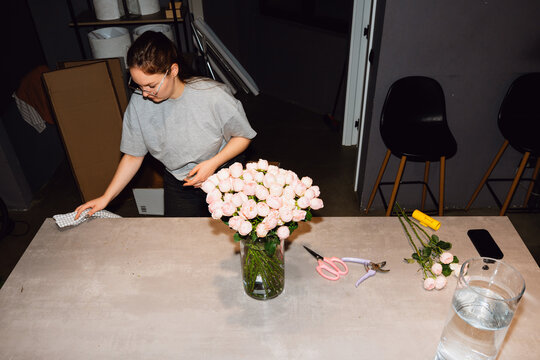 Florist Working Around a Pink Rose Bouquet