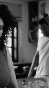 African American couple having heated dispute in kitchen showing marital conflict
