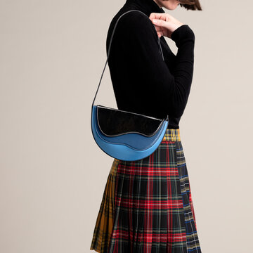 Black Sweater With Blue Handbag And Tartan Skirt