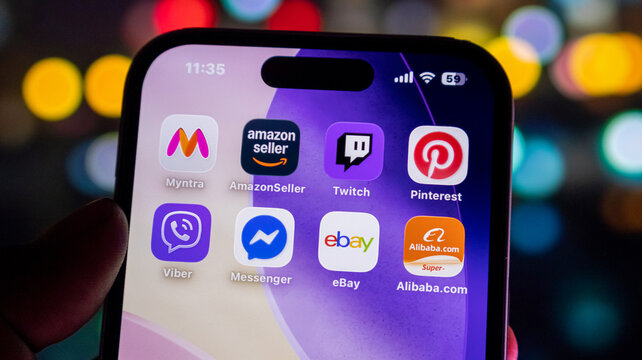 Smartphone screen grid showing popular mobile application icons for shopping and social networking.