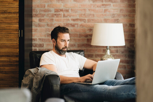Individual working remotely on laptop at home