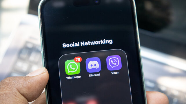 Smartphone screen showing social networking folder with whatsapp discord and viber applications.