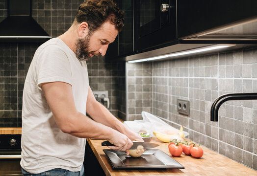 Person preparing food in modern kitchen home cooking
