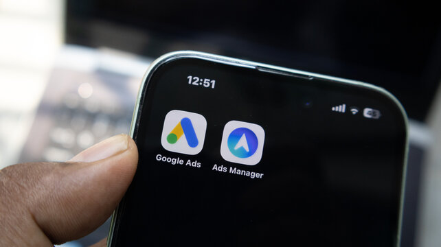 Smartphone screen displaying Google Ads and Meta Ads Manager application icons for digital marketing and campaign management.