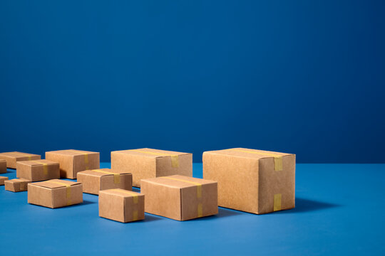 Collection of cardboard boxes arranged on blue background