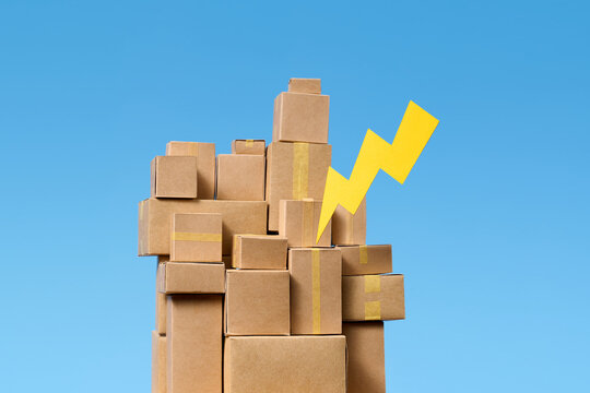 Cardboard boxes stacked high with a yellow lightning bolt