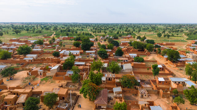 Aerial view of the village of Dambatta featuring traditional mud-brick houses, scattered trees, and dirt paths in the rural landscape of Dambatta, Kano, Nigeria.