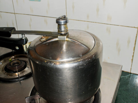 cooking at Indian Kitchen, using pressure cooker