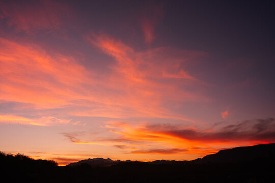 Vivid Sunset Over Mountain Silhouettes