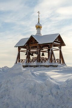 Wooden Orthodox Belfry Covered in Deep Winter Snow