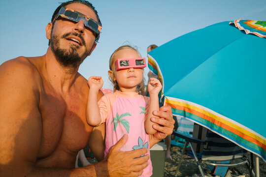 Father and Daughter Watching the Solar Eclipse
