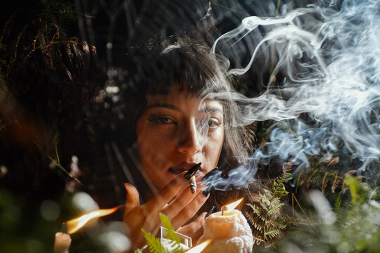 Ethereal Gothic Woman Smoking Through Spiderweb at Night
