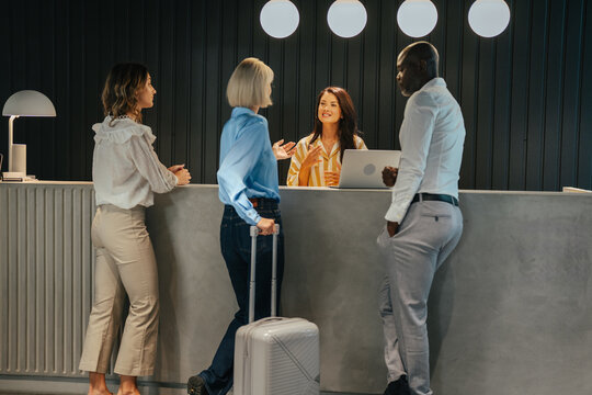 Hotel guests checking in at reception desk