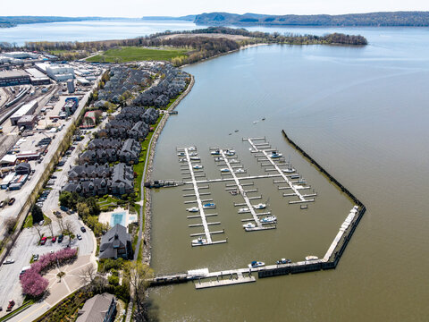 Aerial view of a waterfront marina with boat docks and residential housing.