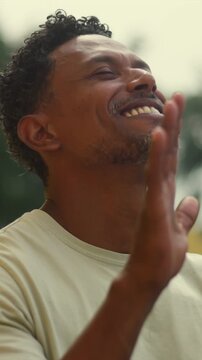 Man in outdoor prayer with hands raised, expressing gratitude, hope, and deep spiritual faith