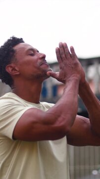 Man facing sky with raised hands in deep prayer expressing gratitude and spiritual hope
