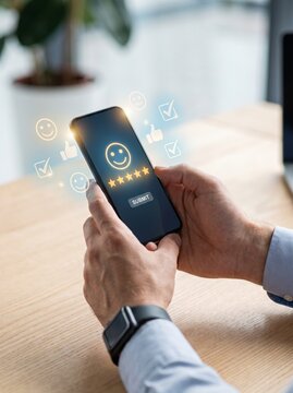 Man hands hold smartphone for online customer review with five yellow stars and submit button.