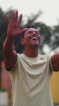 African American man clasping hands with eyes uplifted in outdoor spiritual prayer