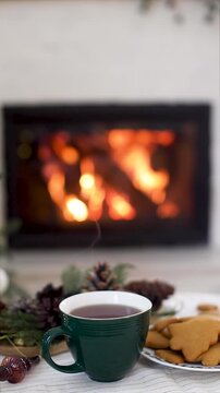 Cozy Christmas Table with Hot Drink, Cookies, and Fireplace, holiday video. Holiday Relaxation, Winter  Hygge Atmosphere, Christmas Eve Celebration