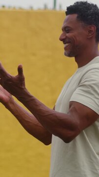 African American man smiling with raised hands in peaceful outdoor spiritual devotion
