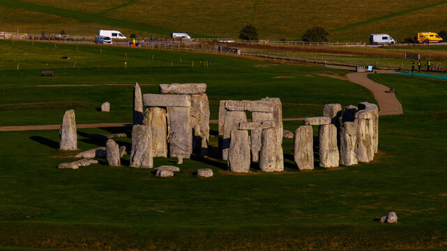 Aerial view of the ancient prehistoric monument Stonehenge, featuring its iconic standing stones arranged in a circle on a grassy plain in Salisbury, England, United Kingdom.