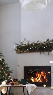 Cozy christmas video. Green Mug with Hot Tea and Gingerbread Cookies in Front of Fireplace. Hygge winter mood, Christmas Holidays.  Peaceful Evening, Festive Season