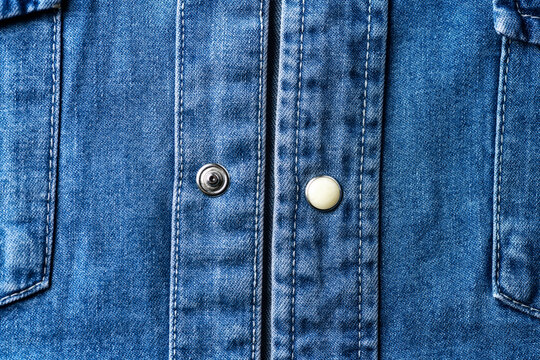 Close up of blue denim shirt with buttons. Soft focus.