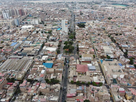 Aerial view of the dense urban landscape featuring a central park, residential buildings, and busy streets in Barranco, Lima, Peru.
