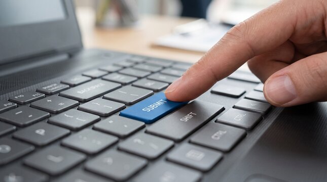 Close up finger press blue submit key on keyboard for online form submission
