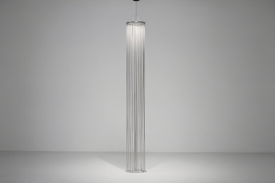Vertical sculpture of silver thread curtain in a quiet white gallery