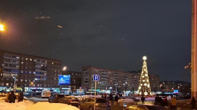 Night city street with illuminated buildings and yellow streetlights, urban nightscape scene, metropolitan atmosphere view.